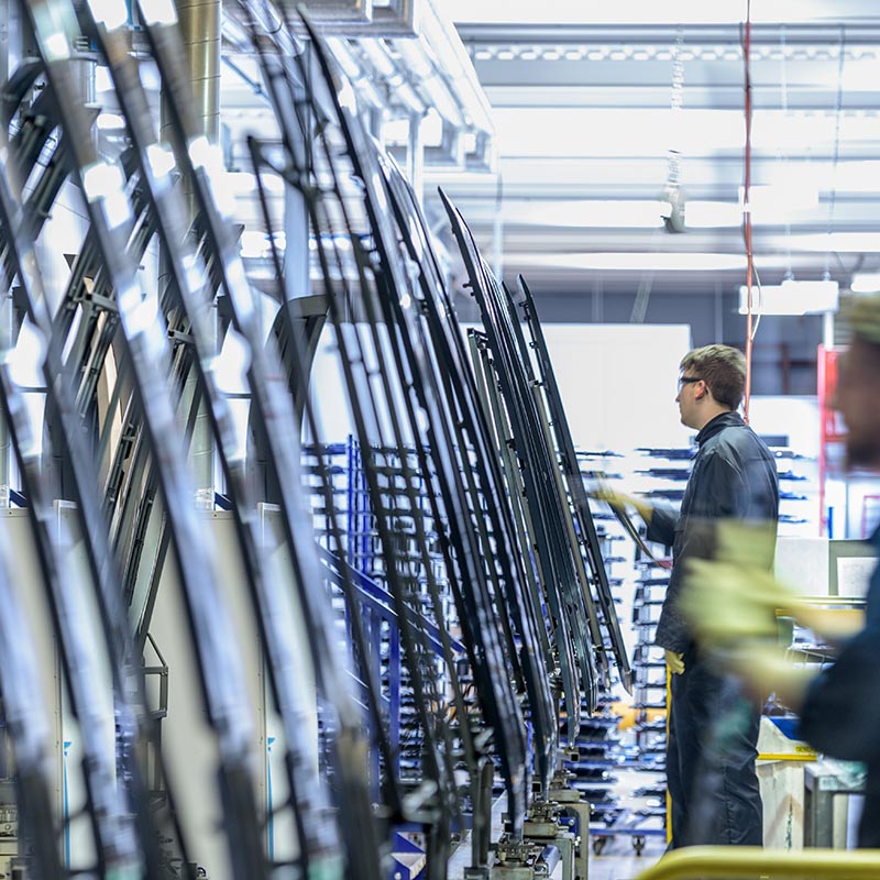 Workers cleaning parts in automotive parts spray paint factory